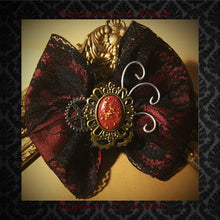 Steampunk Hair Bow Handmade with Silver and Brass Cogs and Gears with a Red and Gold Cameo on Black Lace and Dark Red Ribbon